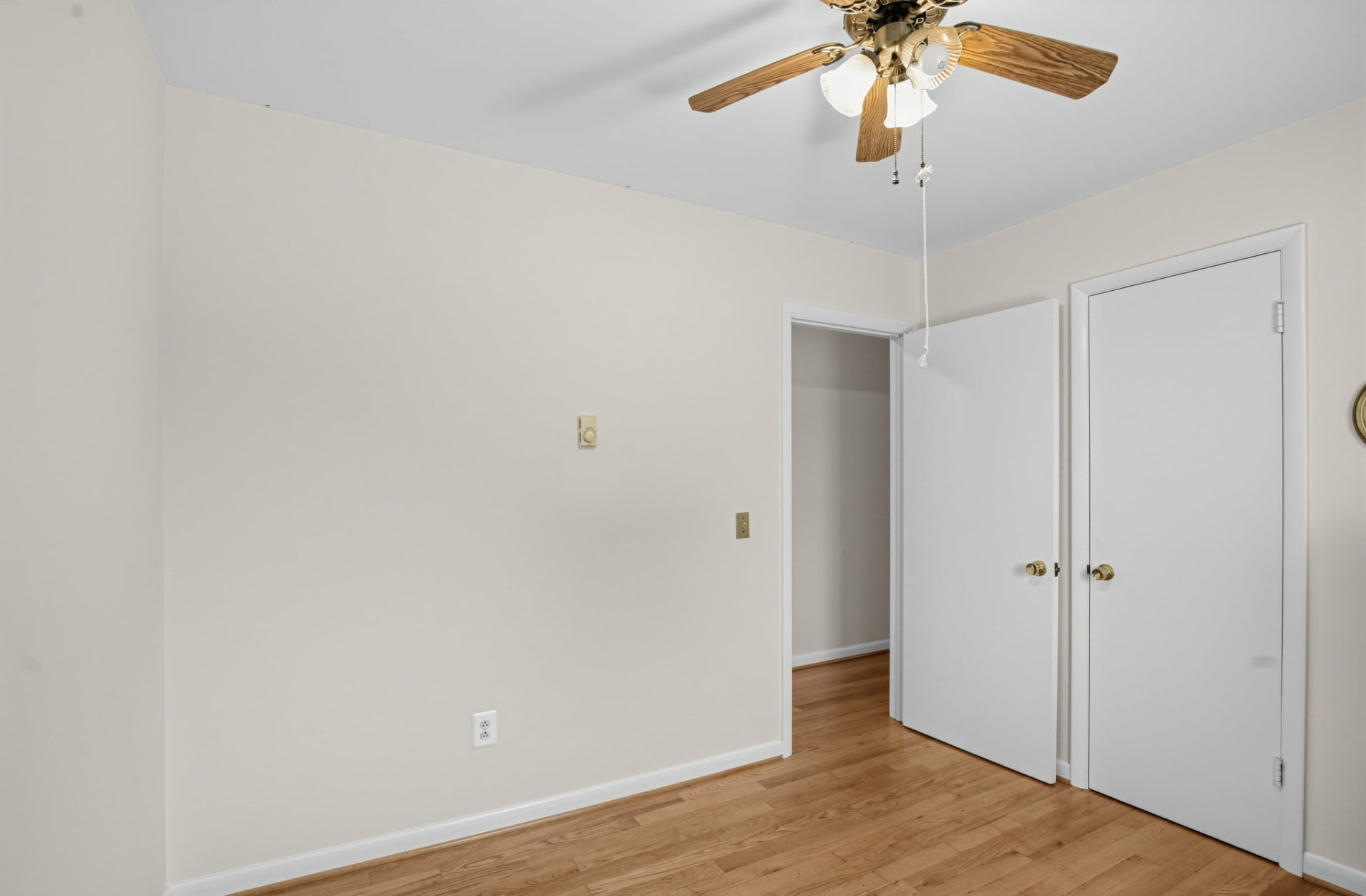Third bedroom with hardwood floors, closet and ceiling fan