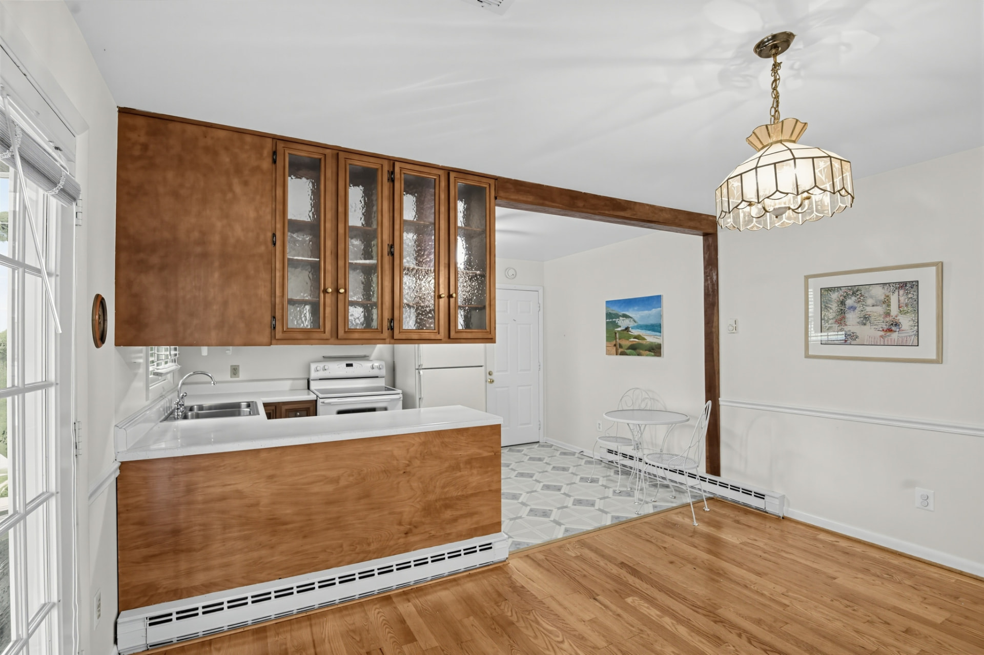 Kitchen peninsula counter with the breakfast nook and pendant light beyond